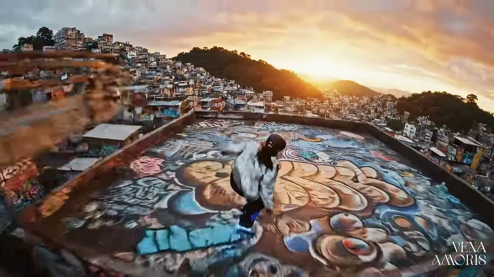 Cena aérea no Brasil: grafite, laje e cidade no fim de tarde.
